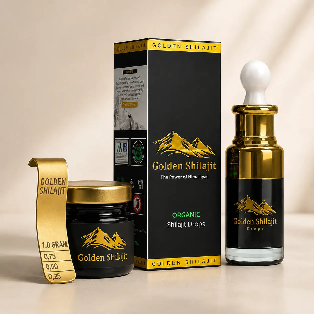 Golden Shilajit drops product set including a glass dropper bottle, a small jar with gold lid, a gold measurement tape, and a black branded box on a warm beige background.