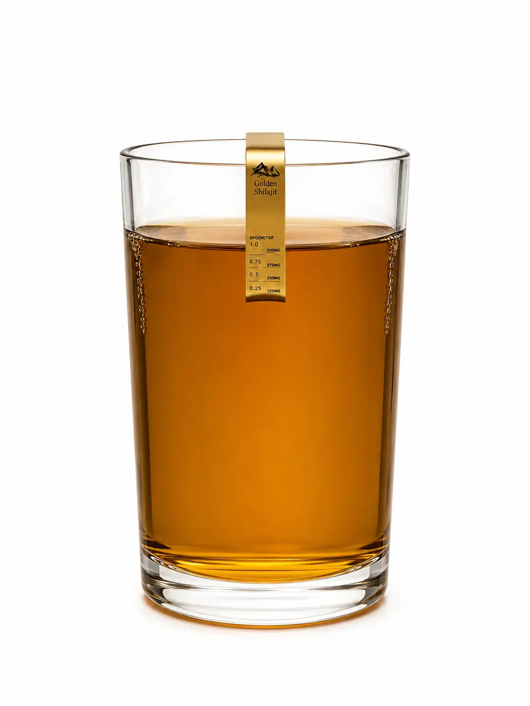 A clear glass tumbler filled with amber liquid, featuring a gold hanging scale label on the side, isolated on a white background.