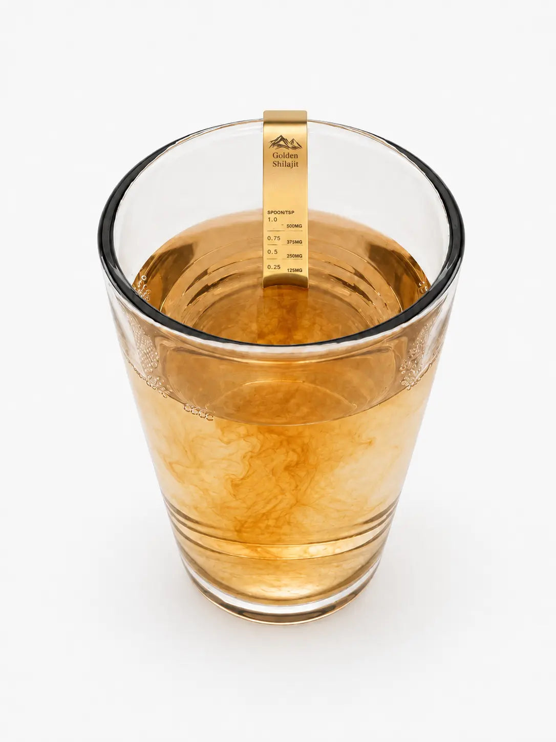 A clear glass measuring cup filled with amber liquid, featuring a gold-colored digital density meter probe inside the cup, set against a plain white background.
