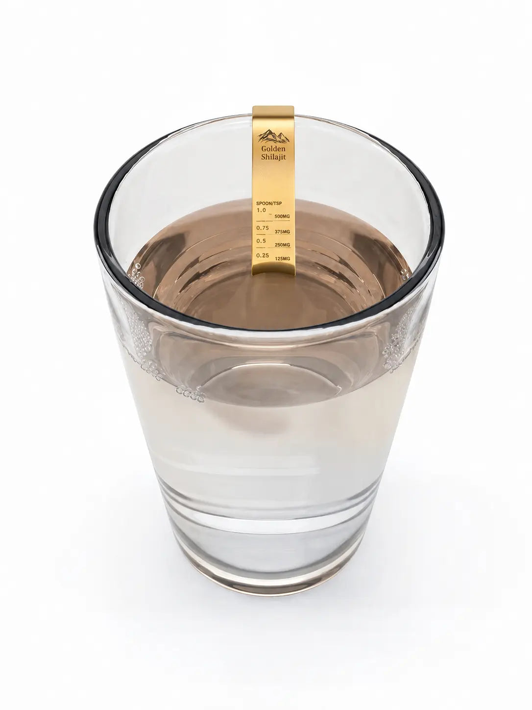 A clear glass cup filled with water on a white background, featuring a small gold-colored test strip hanging from the rim labeled Golden Swatch.