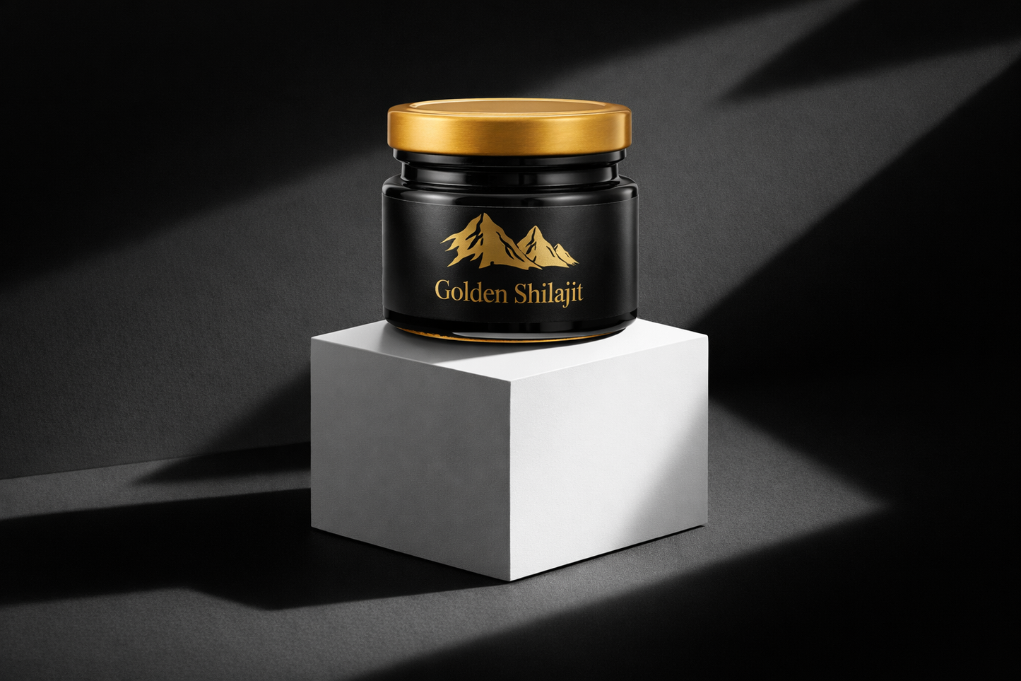 Jar of Golden Shilajit on a white cube with a black background