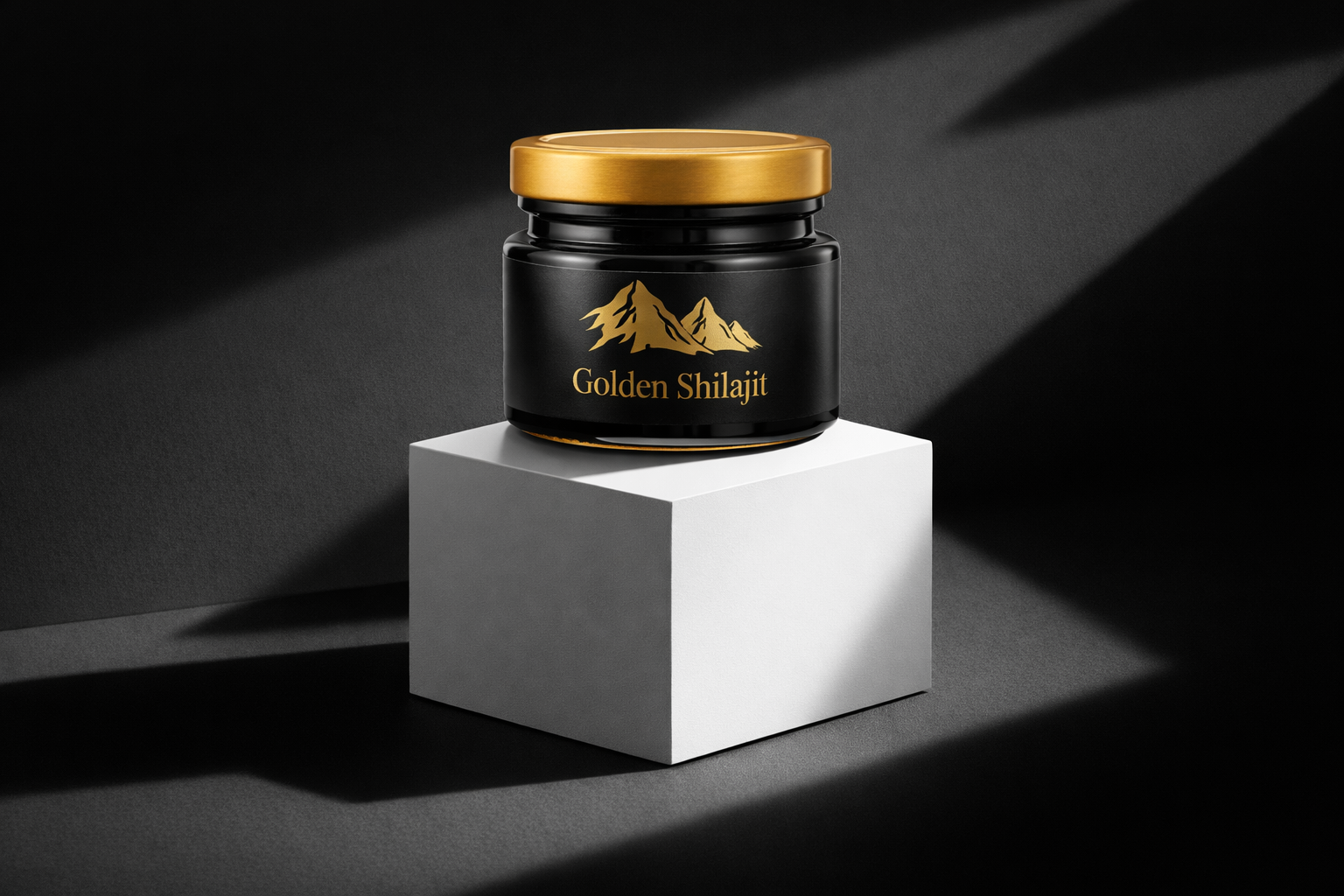 Jar of Golden Shilajit on a white cube with a black background