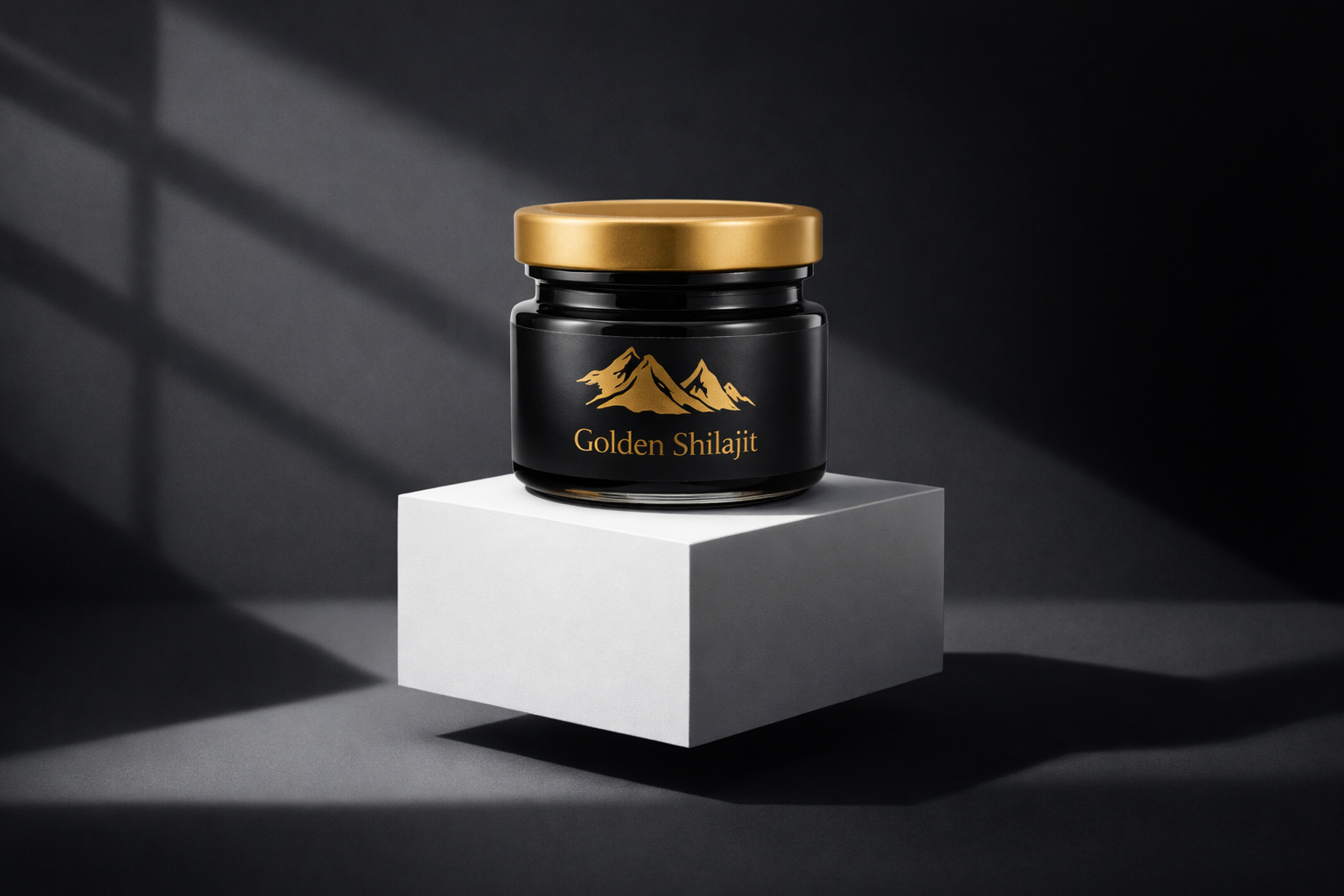 Black jar with gold lid labeled 'Golden Shilajit' on a white platform against a dark background